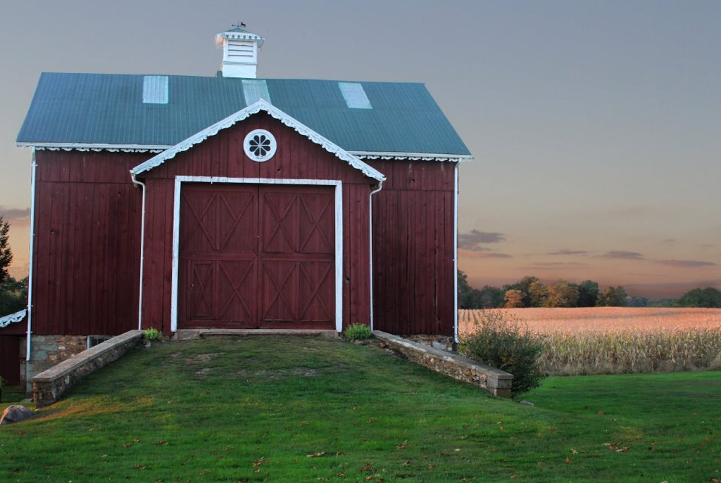 Idyllic view of a red barn with a corn field at sunset in Millersville, MD.